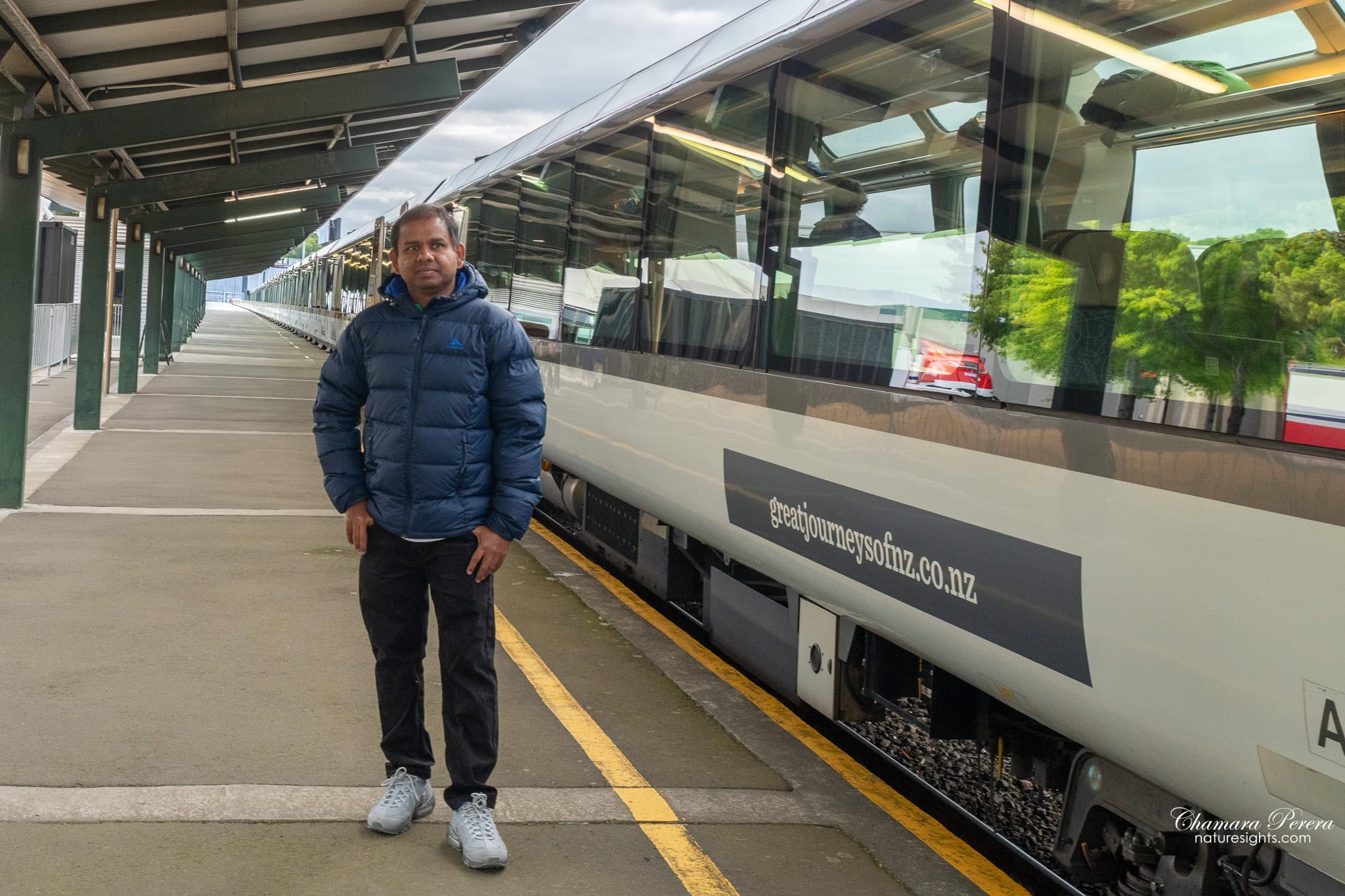 Chamara Perera at TranzAlpine train platform Christchurch station New Zealand