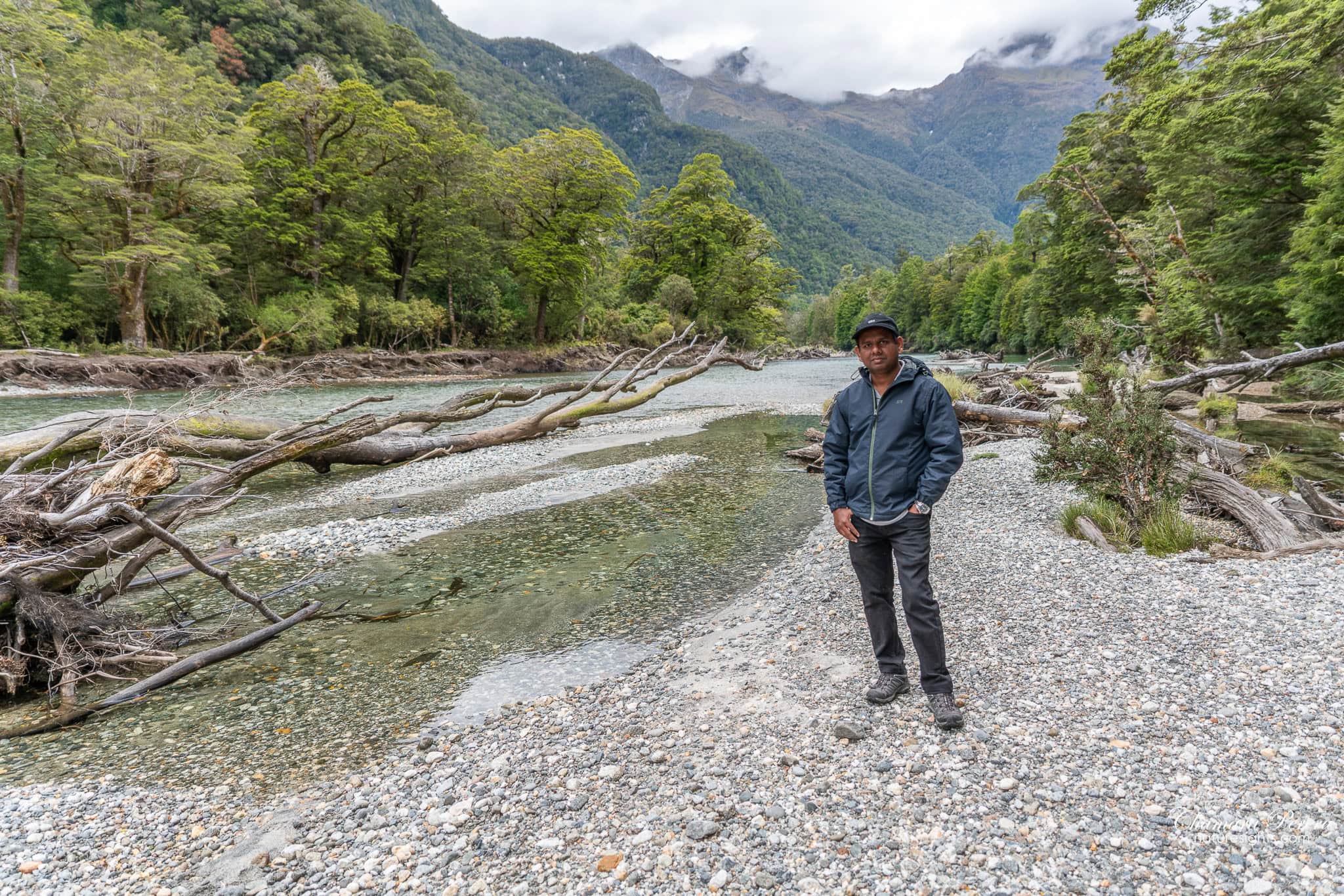hiker on Clinton River shingle bed Milford Track New Zealand