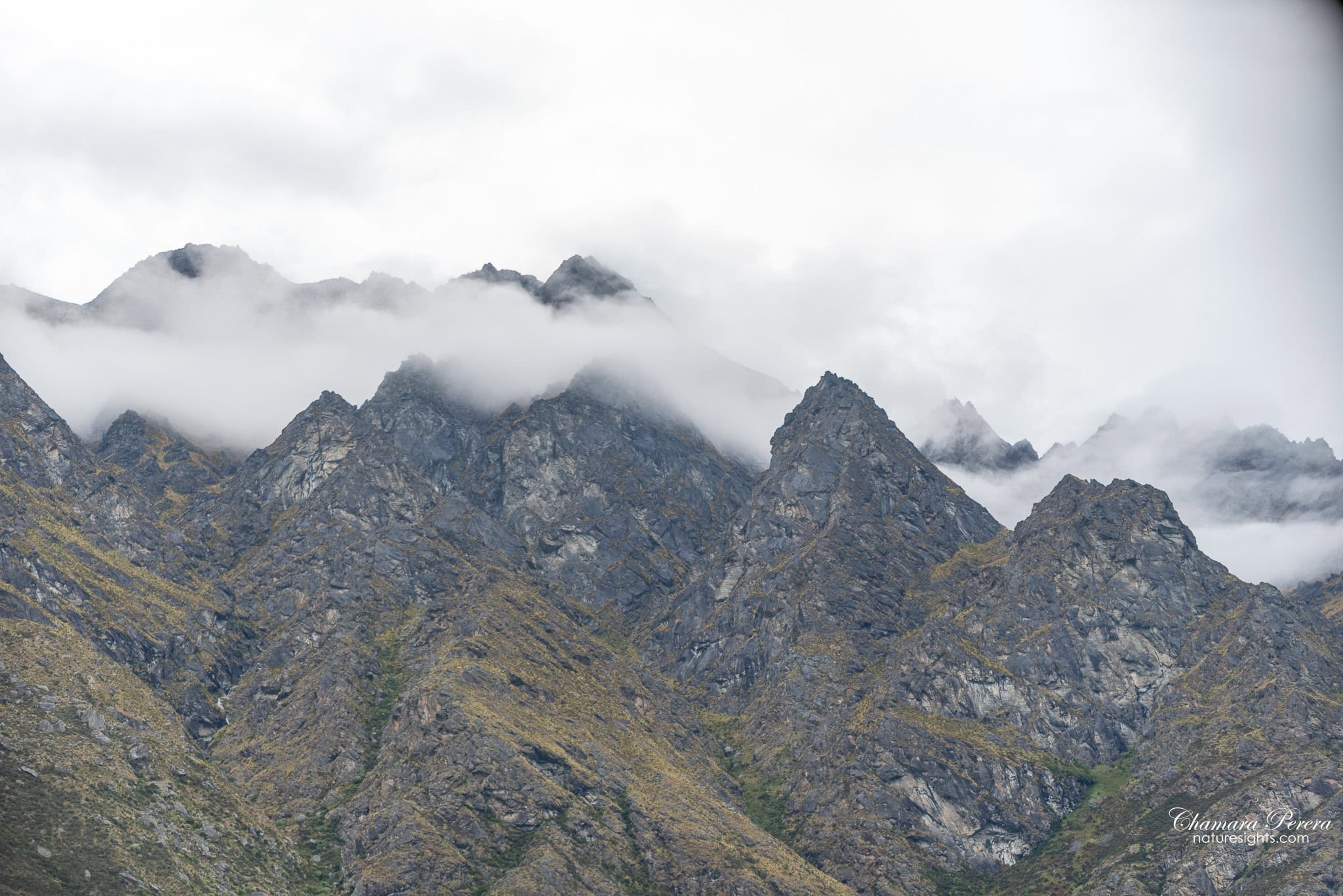 Fiordland jagged mountain peaks with low cloud near Te Anau New Zealand