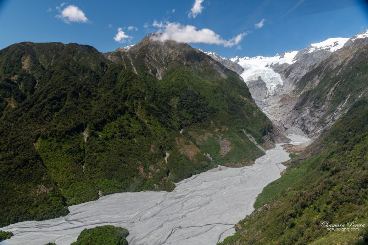 Franz Josef Glacier valley aerial view with braided river and rainforest New Zealand
