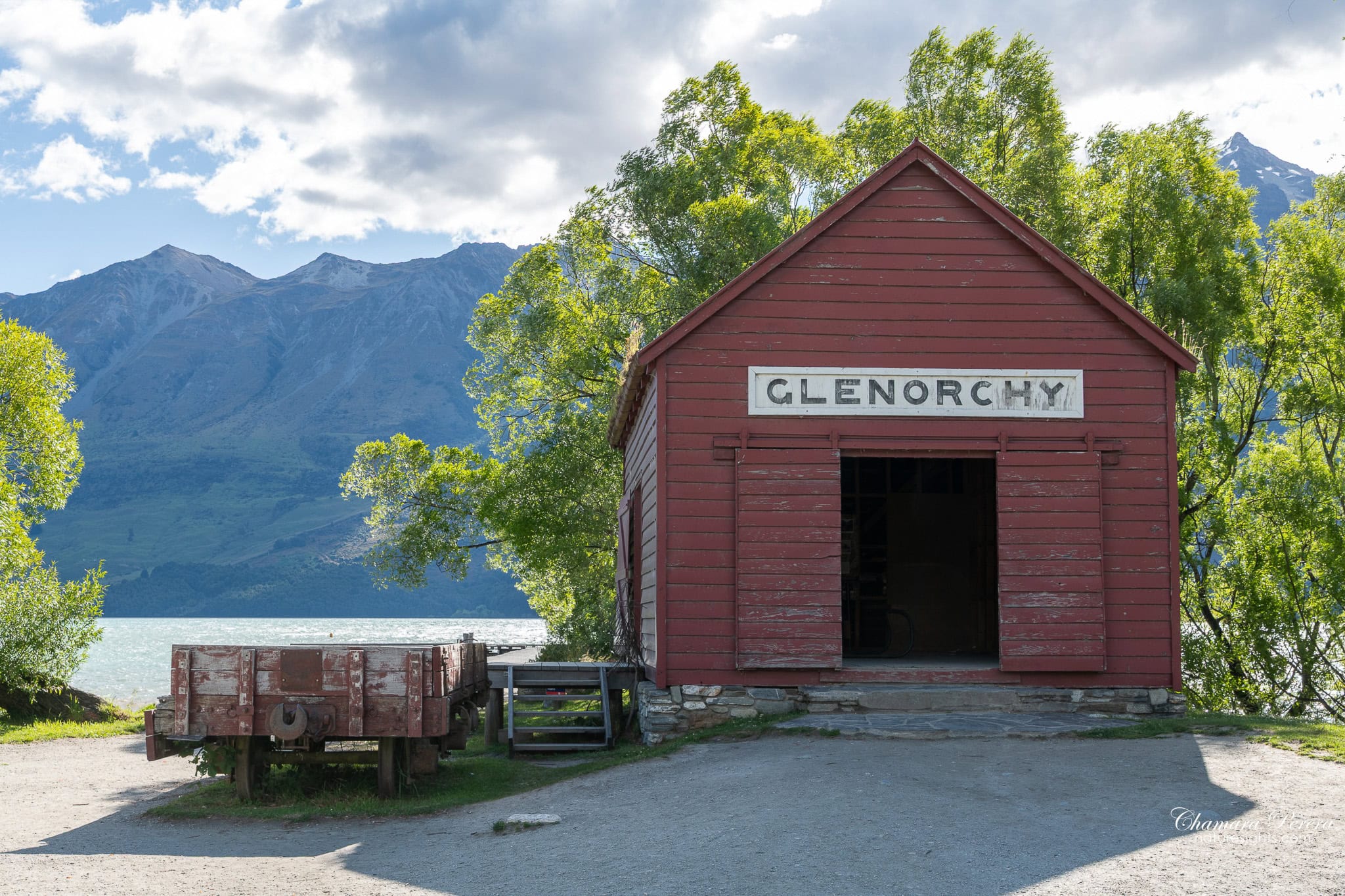 Glenorchy wharf red boathouse with GLENORCHY sign and old wagon New Zealand