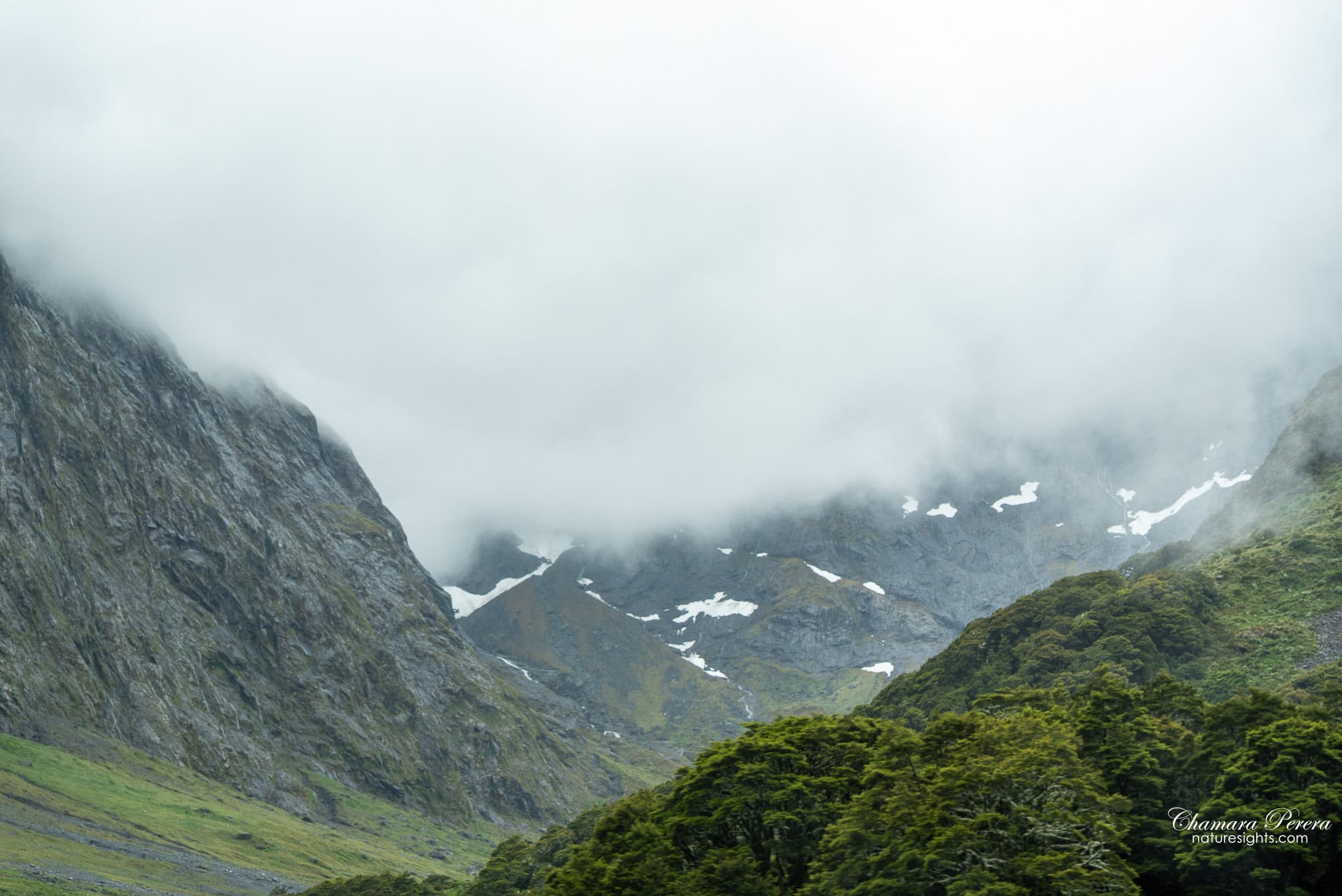 Homer Tunnel area with snow on rocky mountains Milford Sound road New Zealand