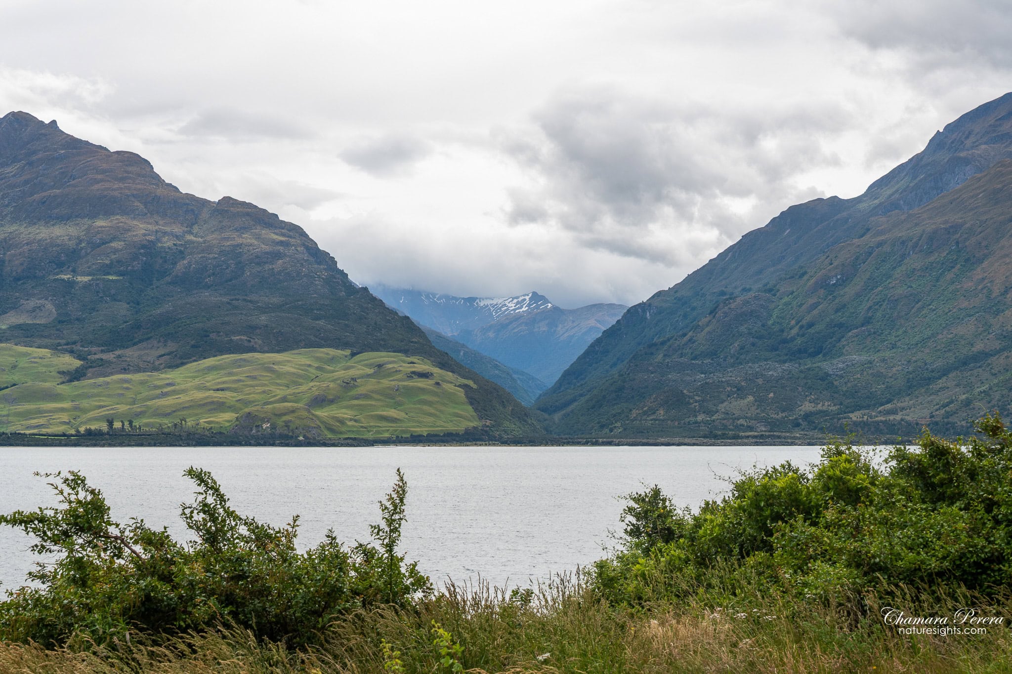 Lake Hawea with snow capped mountains and valley gap New Zealand