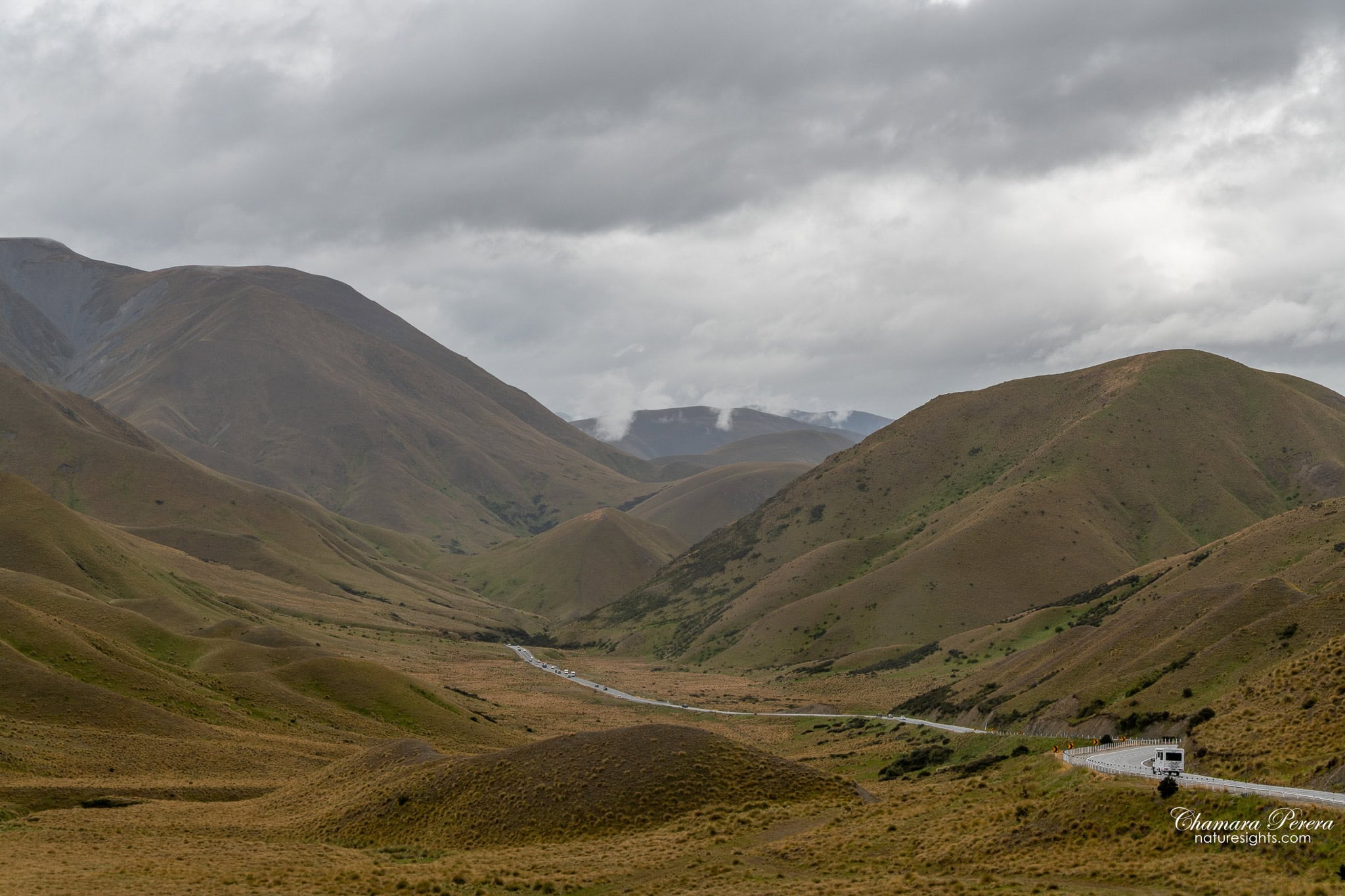 looking down Lindis Pass descent New Zealand with road below
