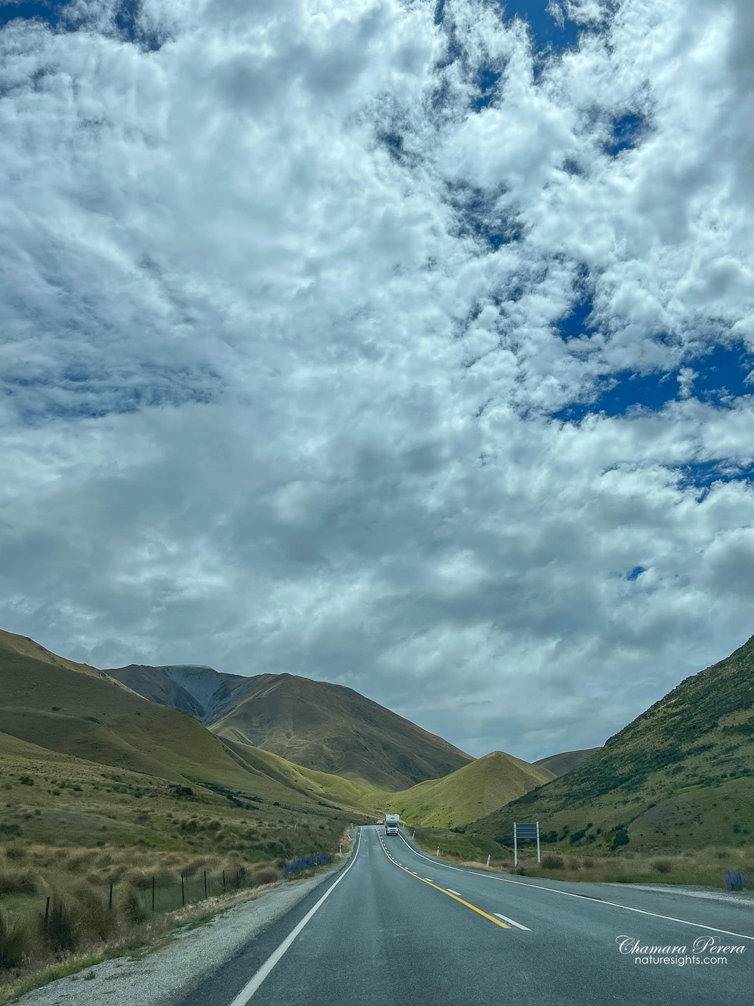 driving State Highway 8 through Lindis Pass New Zealand dramatic sky