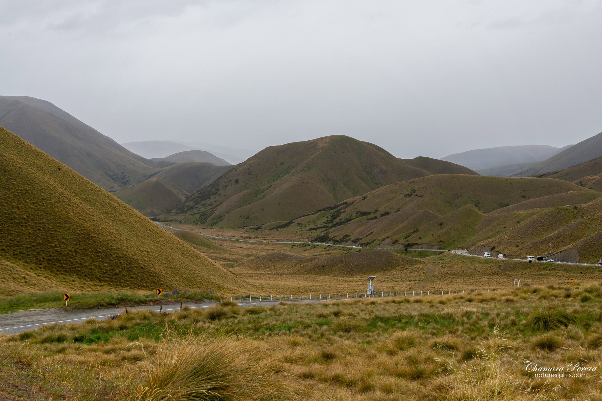 wide valley view at Lindis Pass New Zealand with winding road