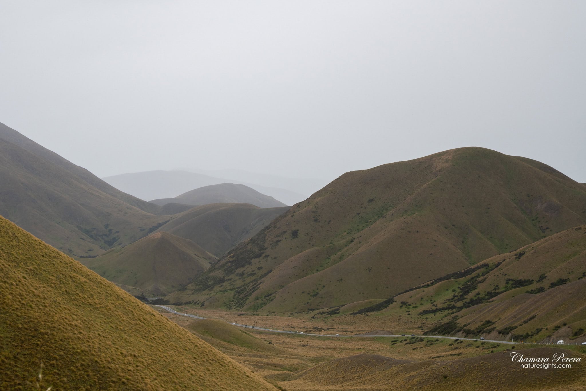 Lindis Pass valley with road below moody clouds New Zealand
