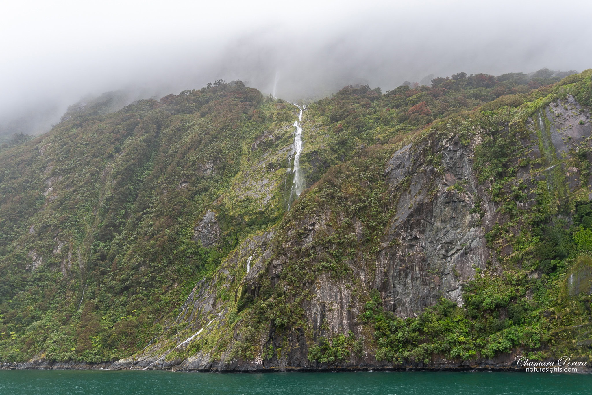 Waterfall on cliff face Milford Sound Fiordland New Zealand