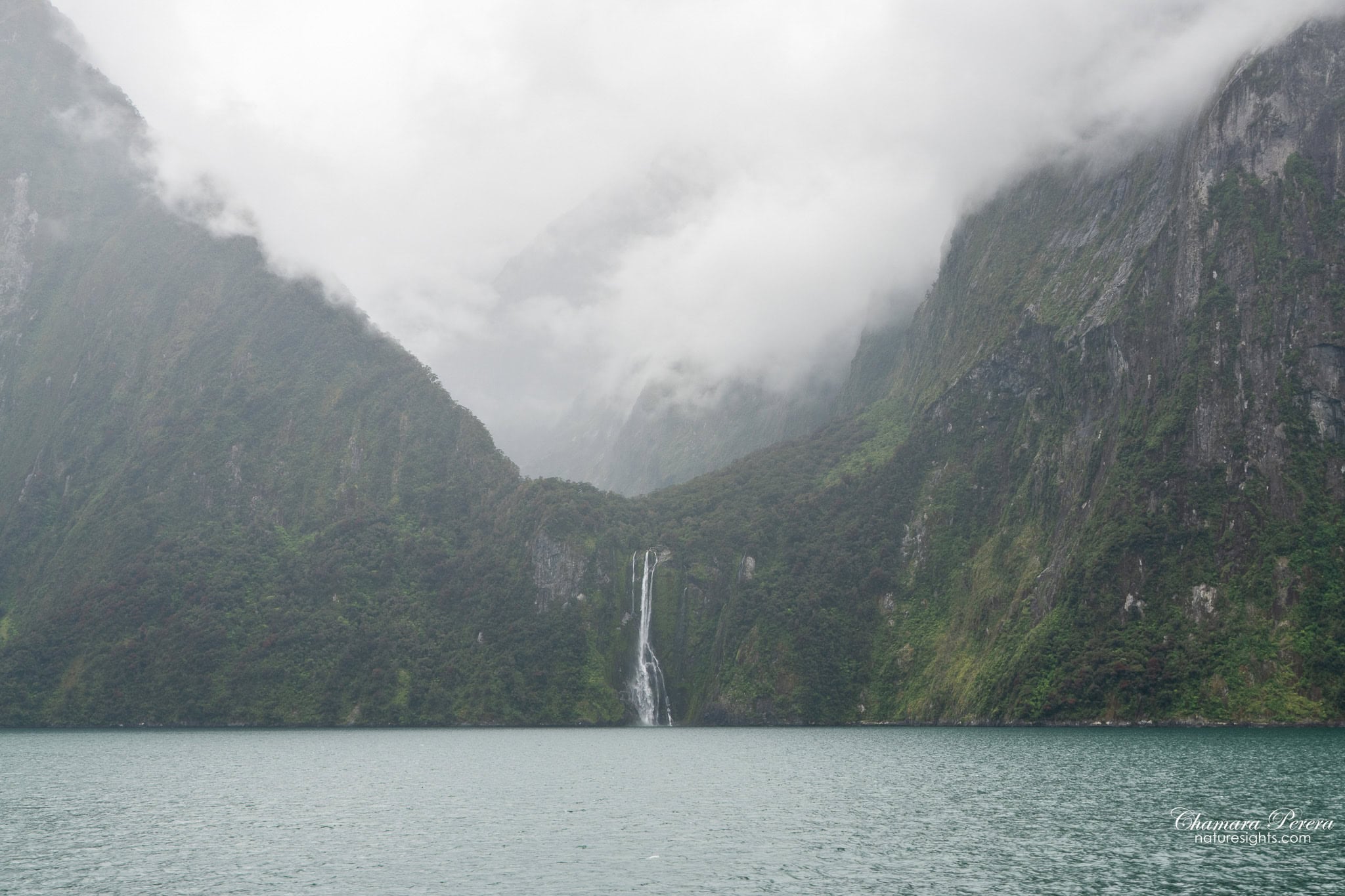Milford Sound valley with distant waterfall Fiordland New Zealand