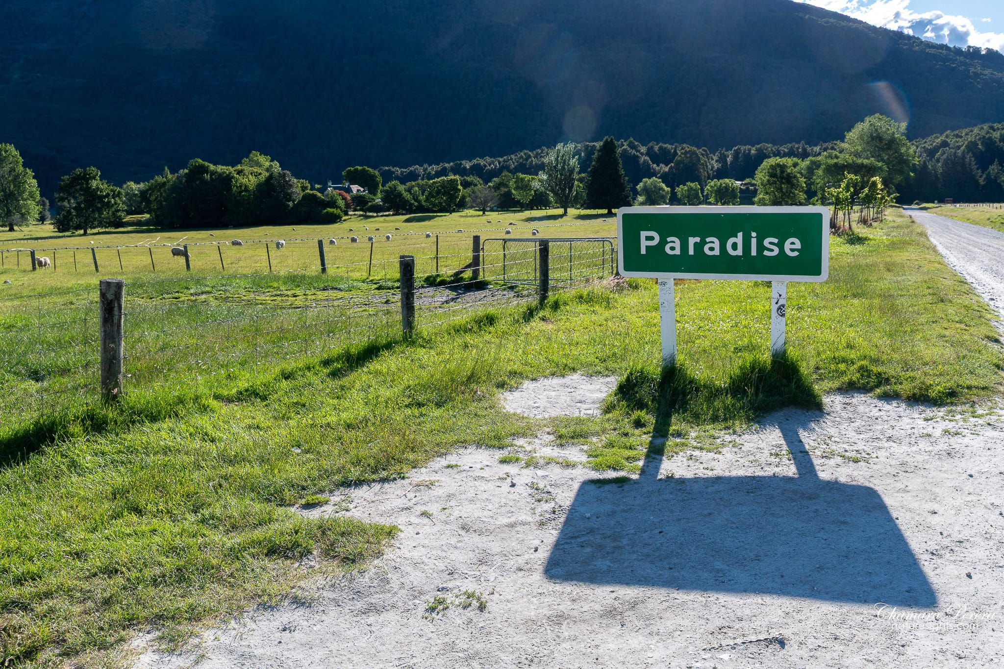Paradise New Zealand road sign with mountains and farmland