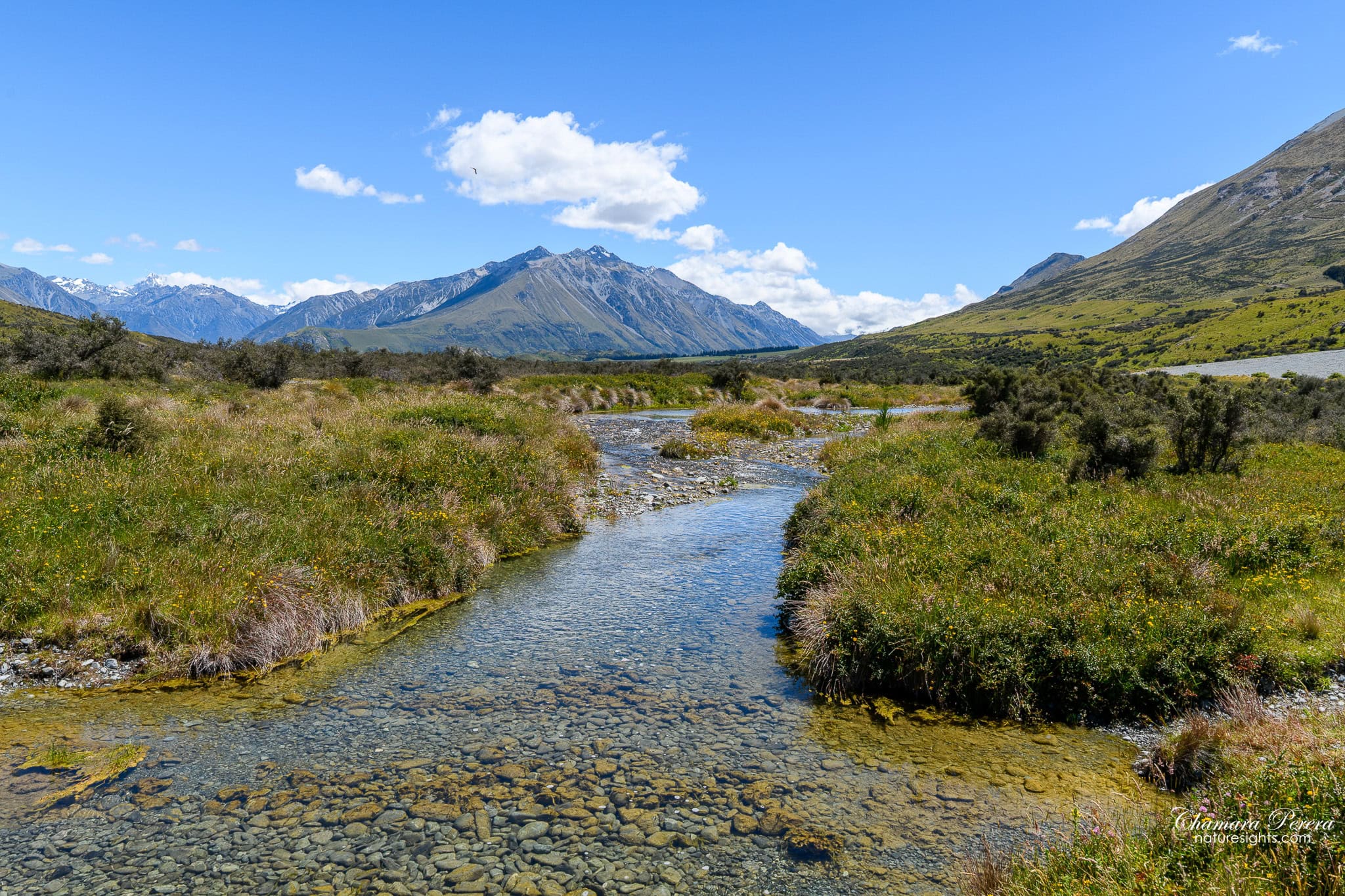 Clear shallow stream with mountains Hakatere Conservation Park New Zealand