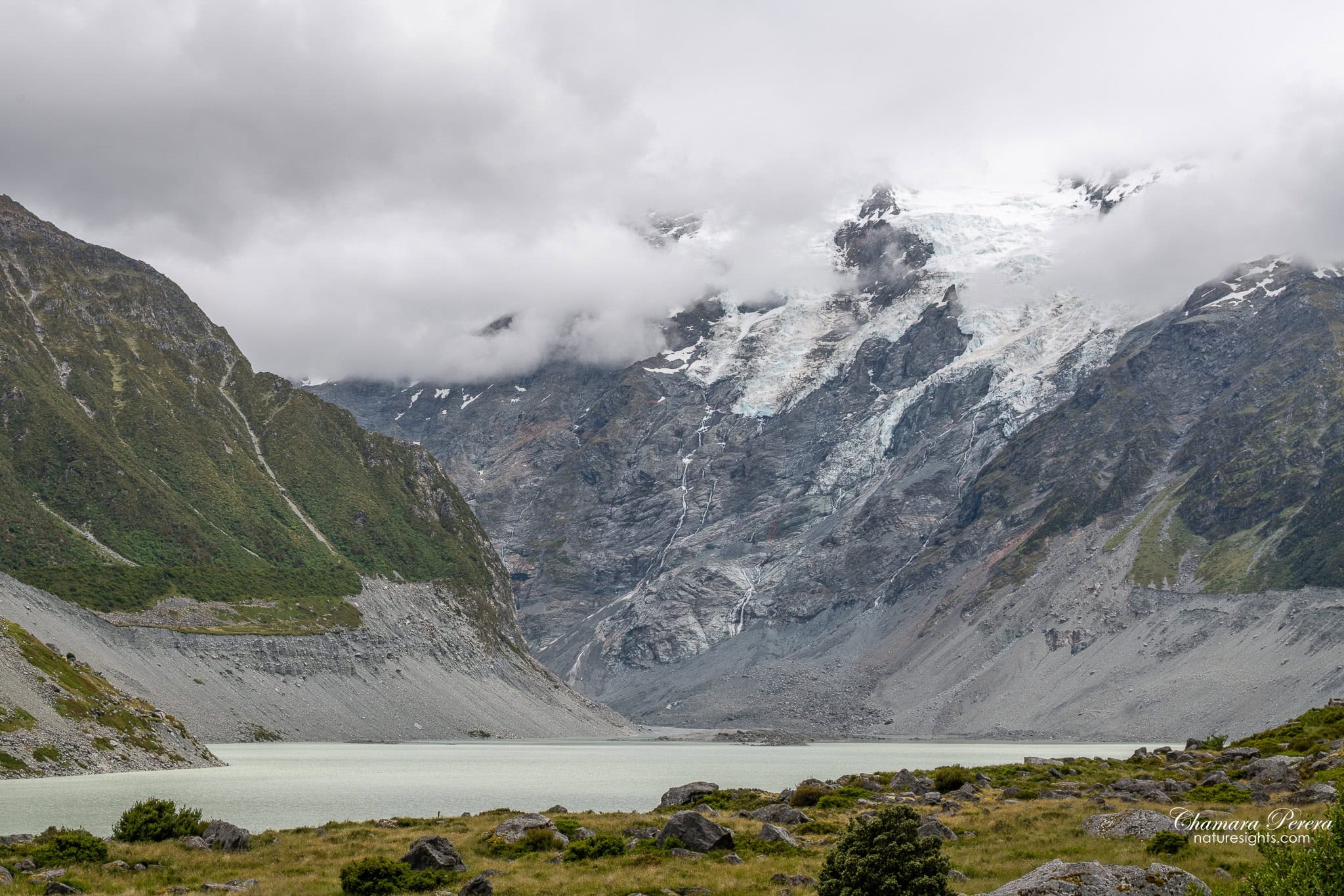 Hooker Lake with glacier face and waterfall Mount Cook New Zealand