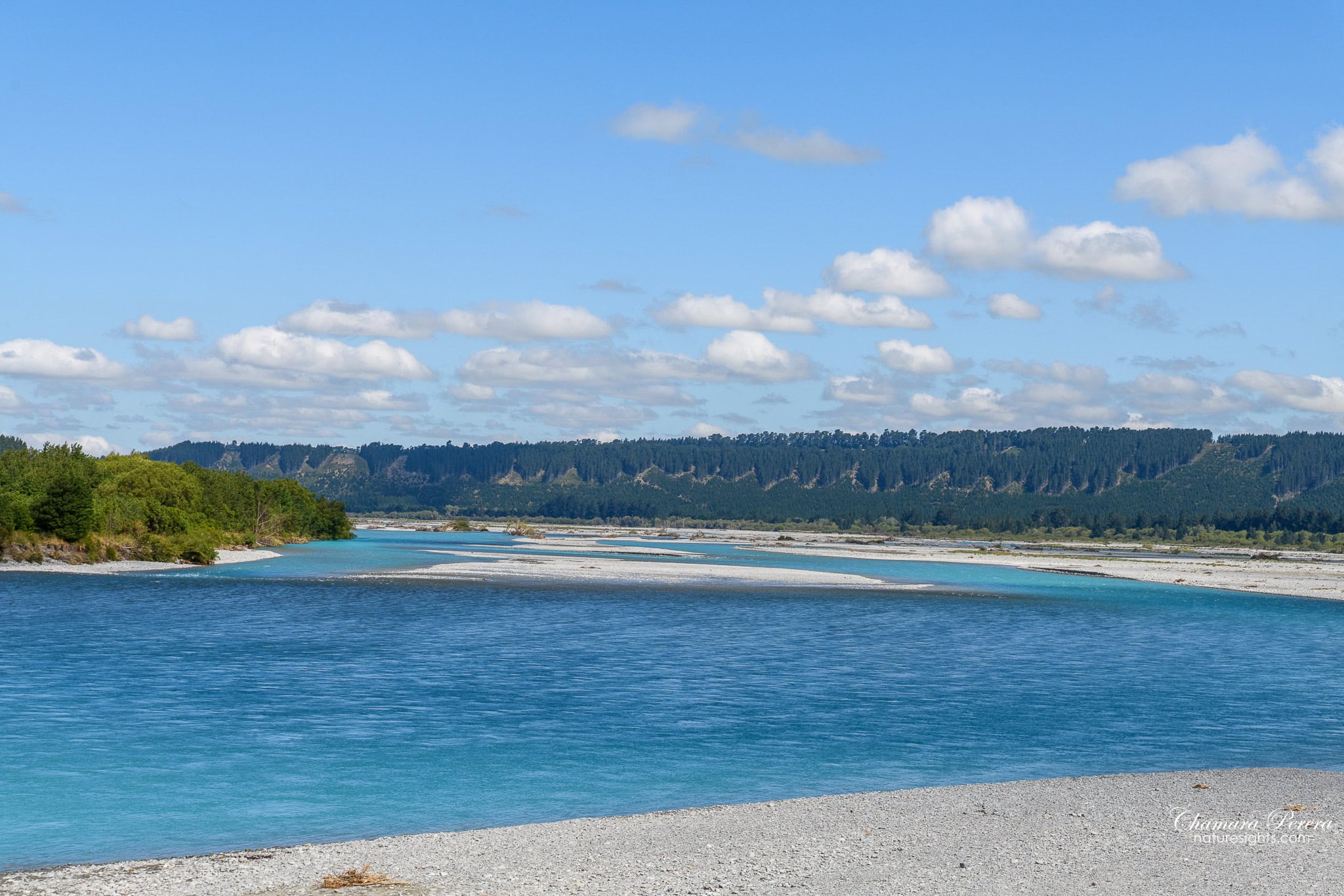 Wide braided Rakaia River with multiple turquoise channels crossing pale gravel bars New Zealand