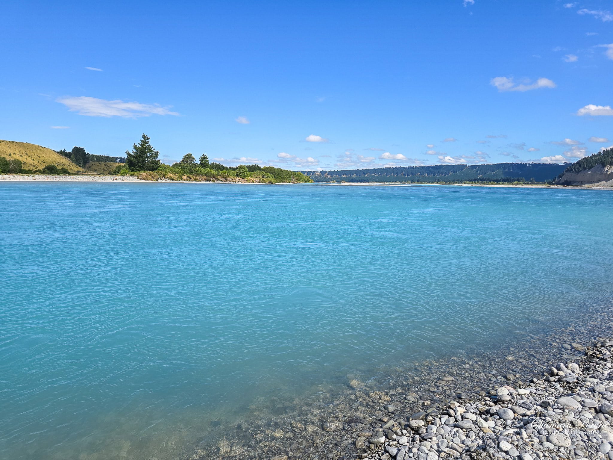 Clear turquoise Rakaia River water from rocky pebble bank Canterbury New Zealand