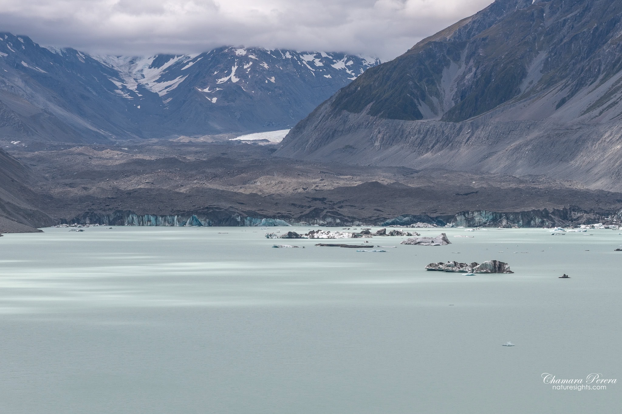Tasman Glacier blue ice terminal face close up with icebergs Mount Cook New Zealand