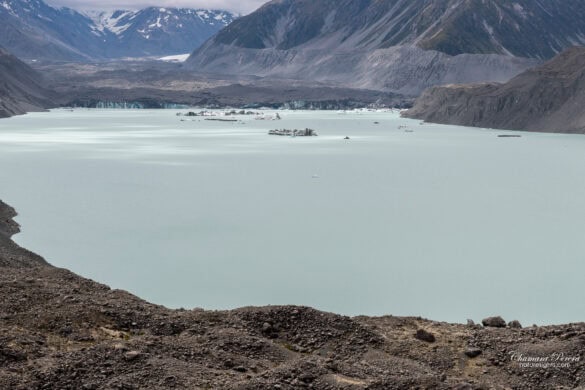 Tasman Glacier terminal ice face with icebergs floating in the lake Mount Cook New Zealand