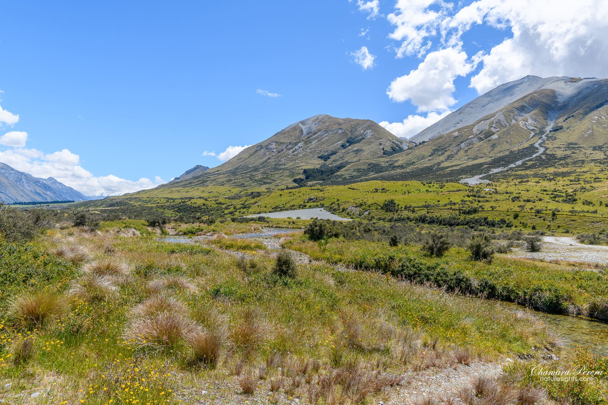 Tussock grassland and mountains approaching Mount Sunday New Zealand